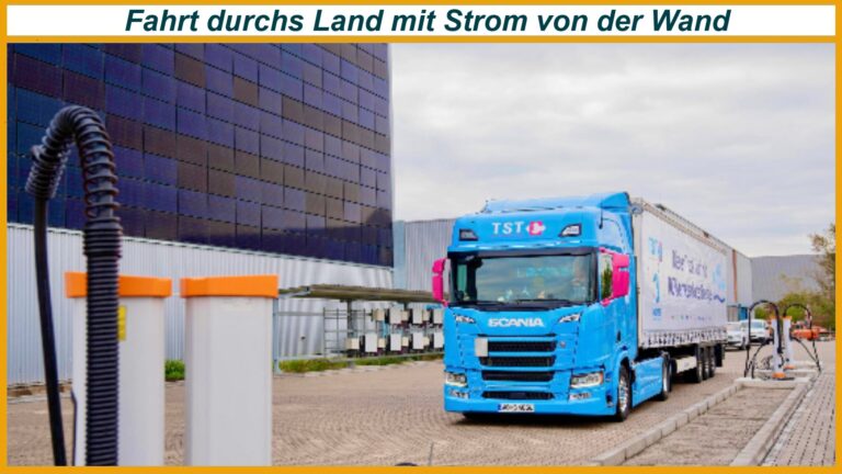 E Lkw lädt an Ladestation vor Logistikhalle mit großer Photovoltaik Fassade in Worms